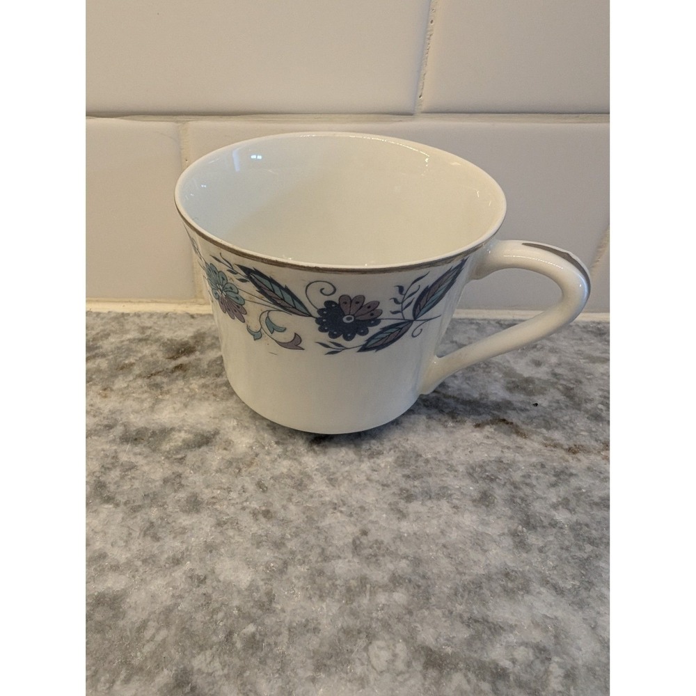 Genuine Porcelain China tea cup w/ blue and purple flowers & Silver Edging